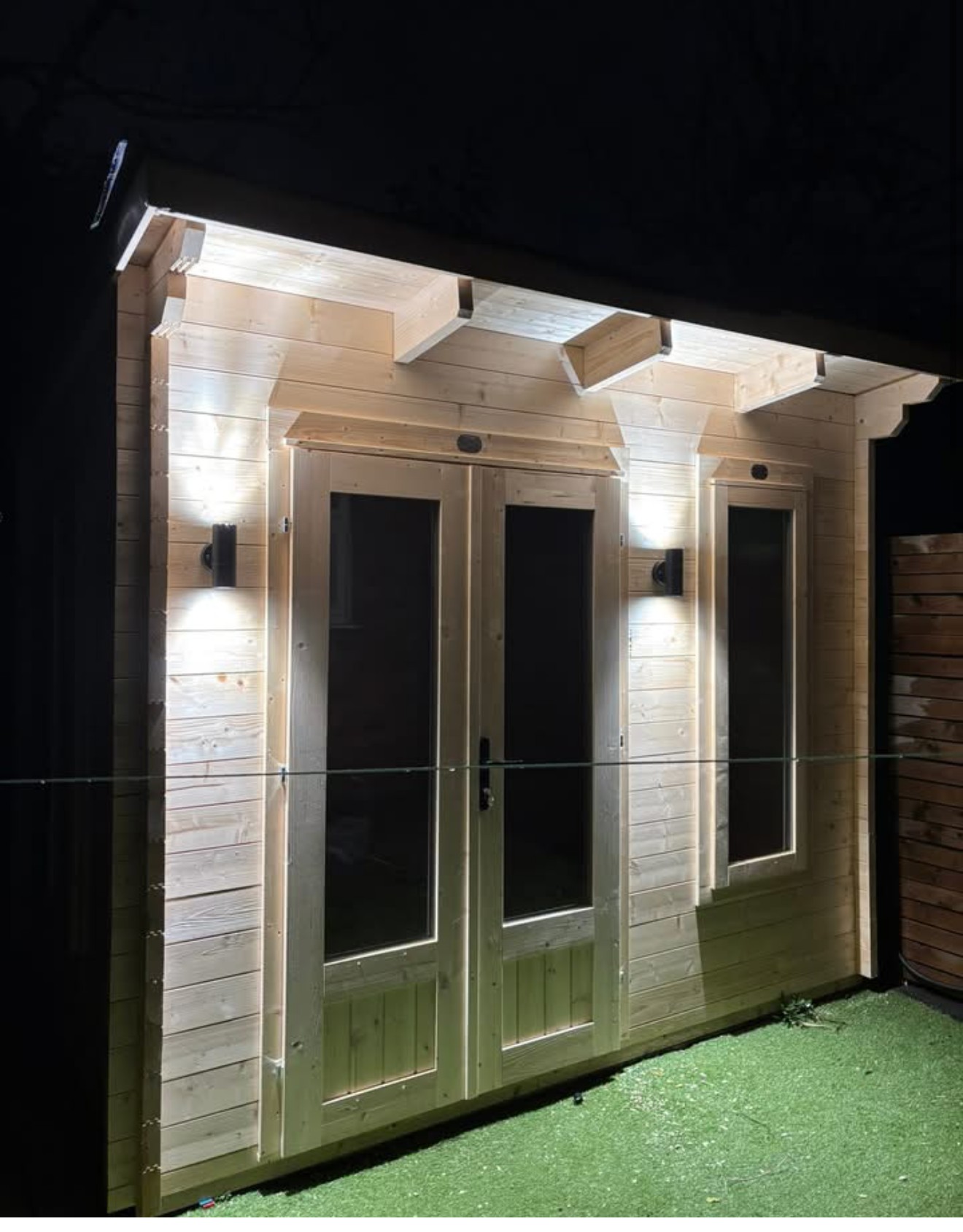 Garden room external wall lighting installation at night